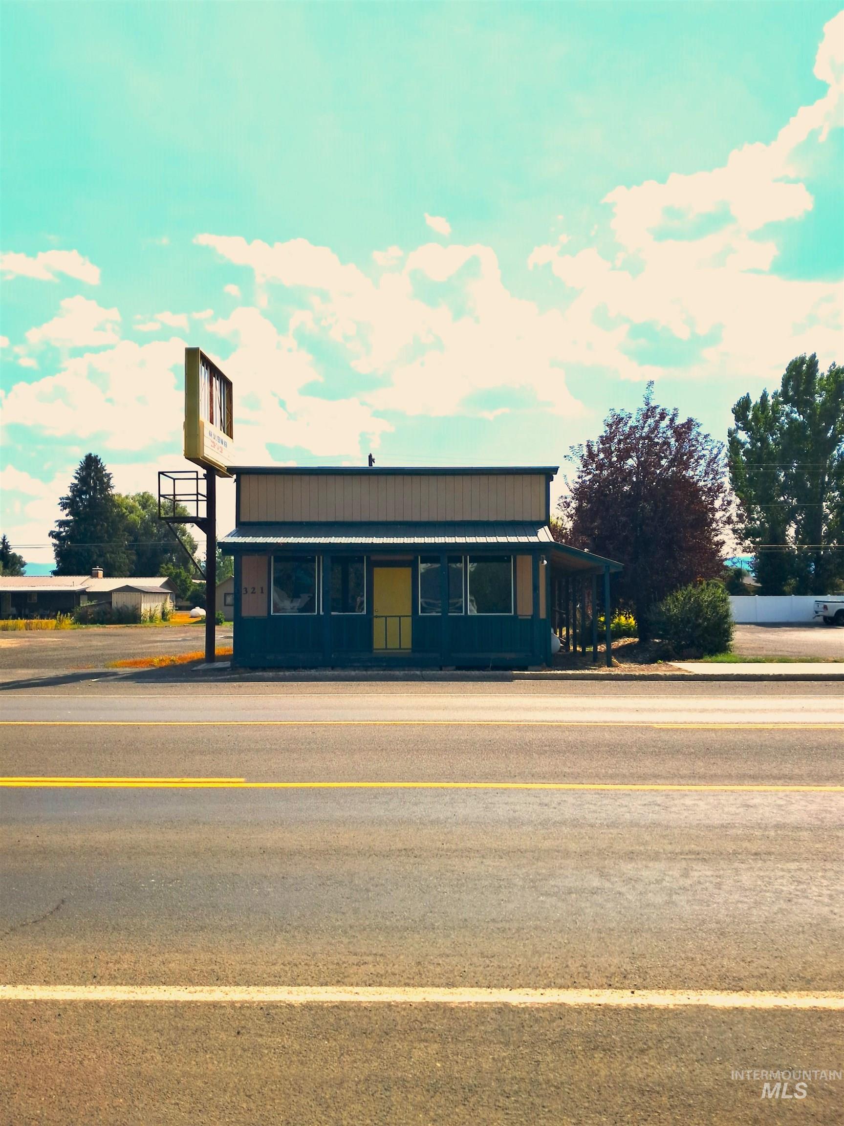 View of front facade with a metal roof and covered porch