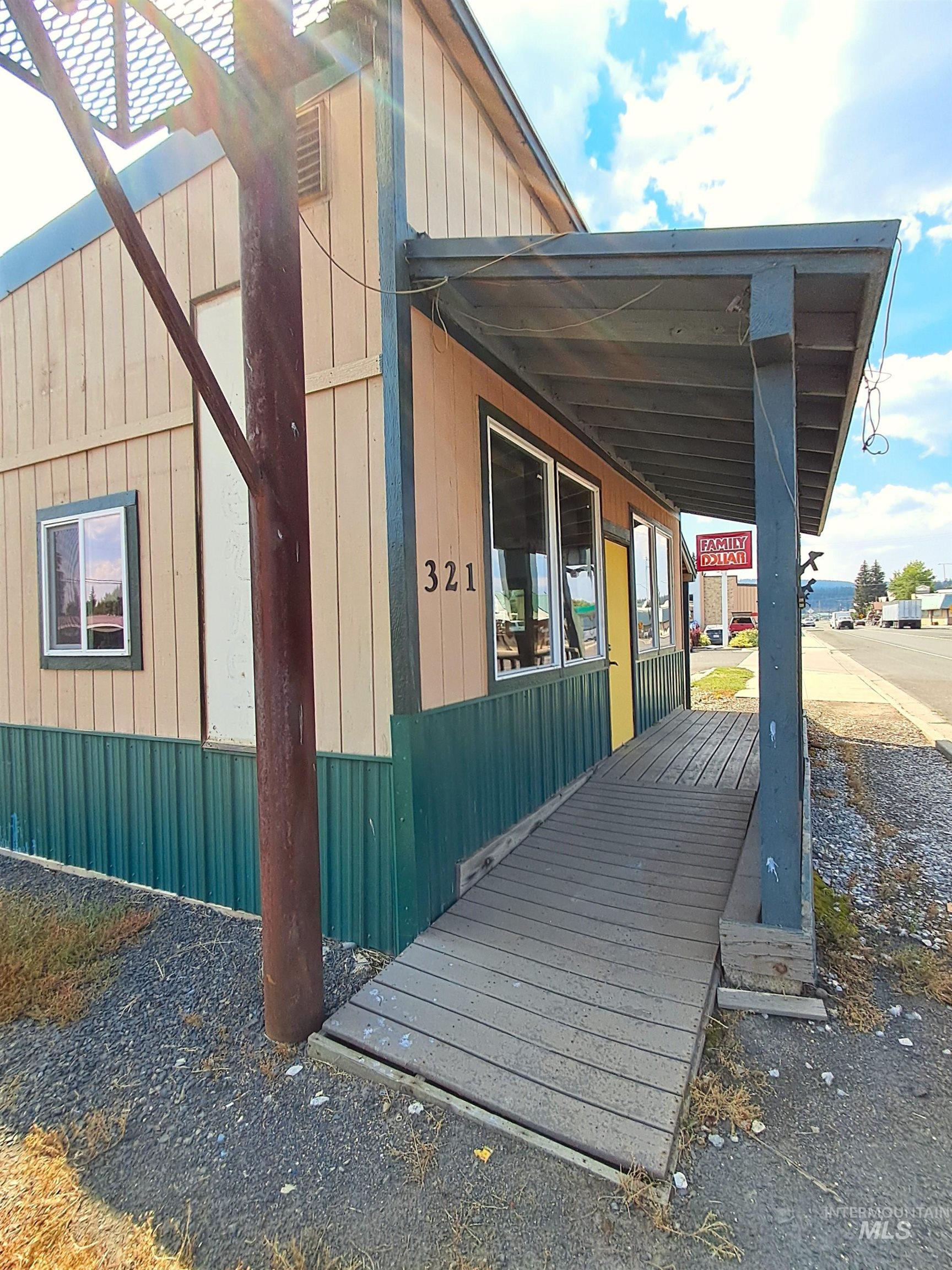 View of side of property featuring covered porch