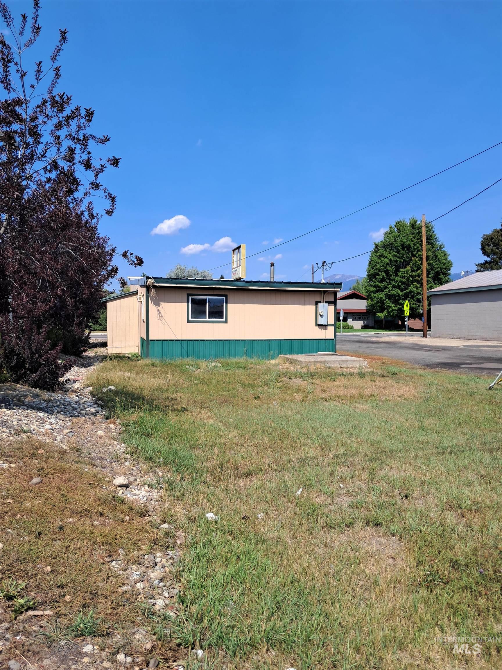 View of side of home featuring a lawn