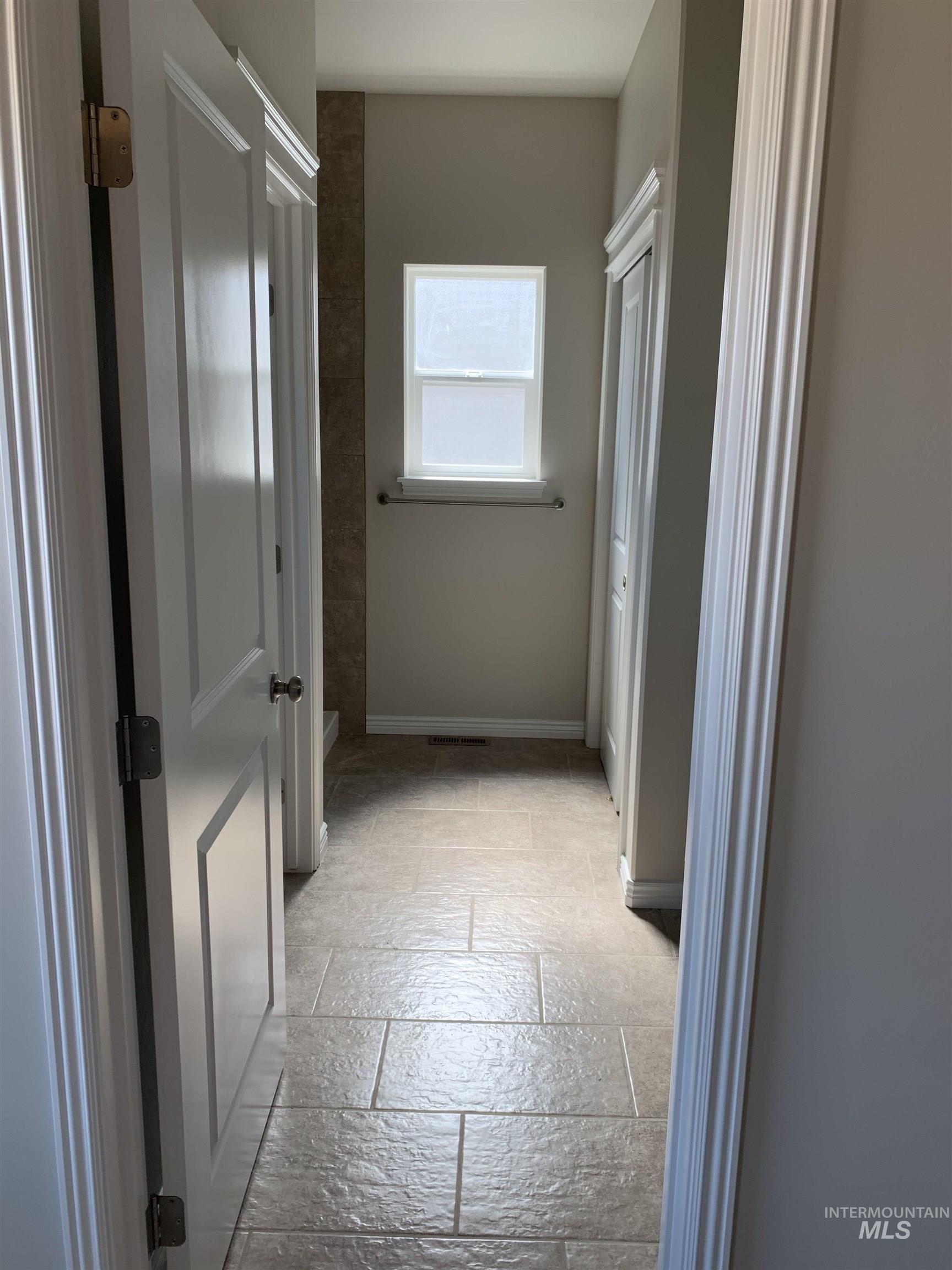Bathroom featuring stone tile floors and toilet