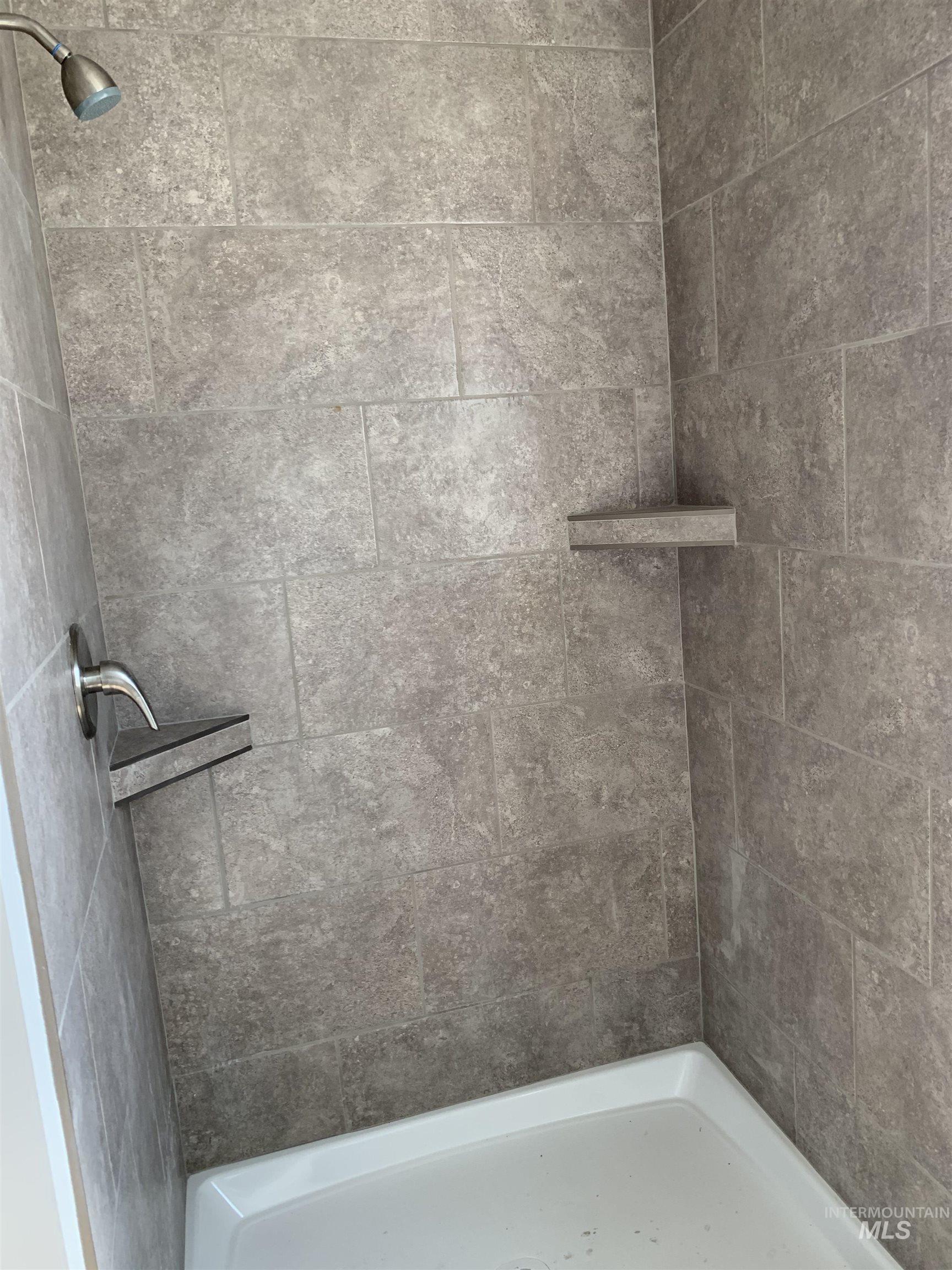 Full bath featuring tiled shower