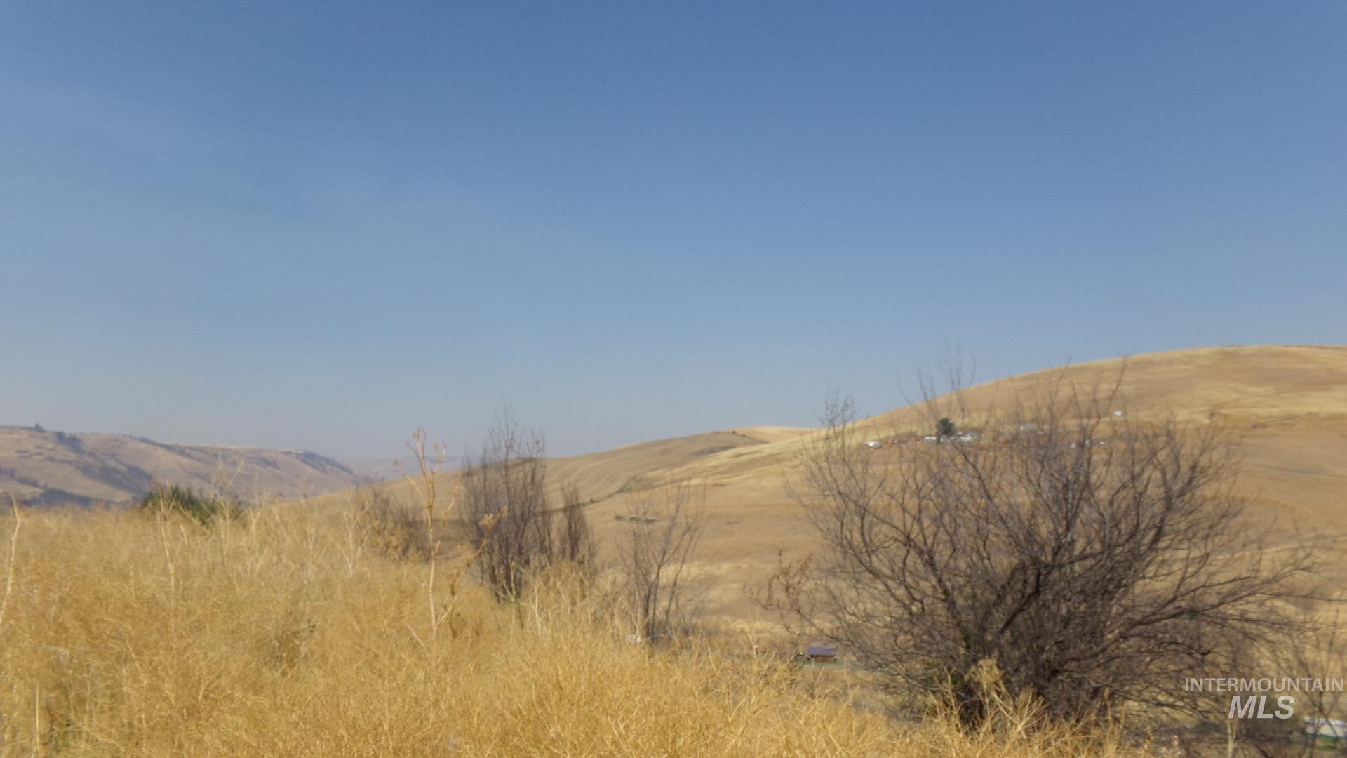 View of mountain backdrop with rural landscape