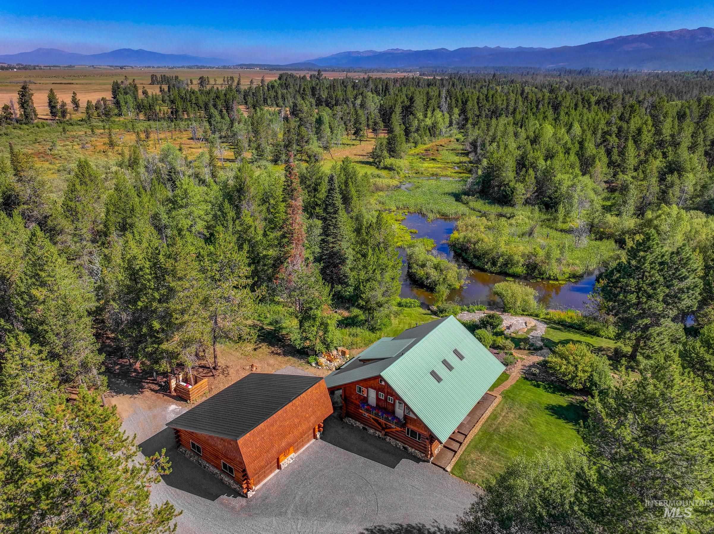 View of subject property featuring a water and mountain view and a heavily wooded area