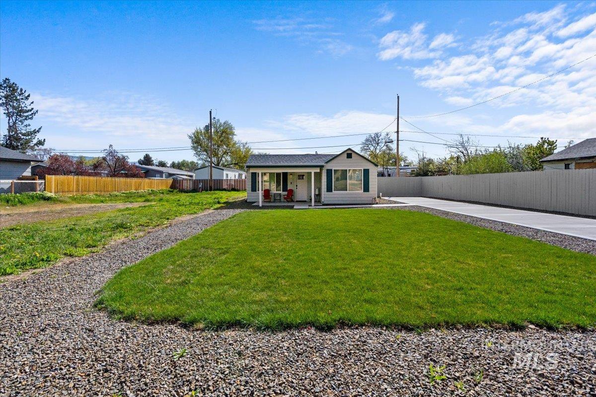 View of front facade with a fenced backyard and a patio area