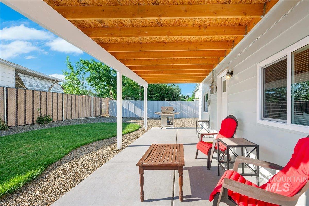Fenced backyard featuring a patio area and area for grilling