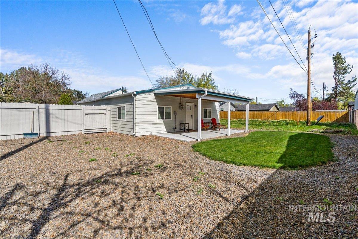 Rear view of property with a patio area and a fenced backyard