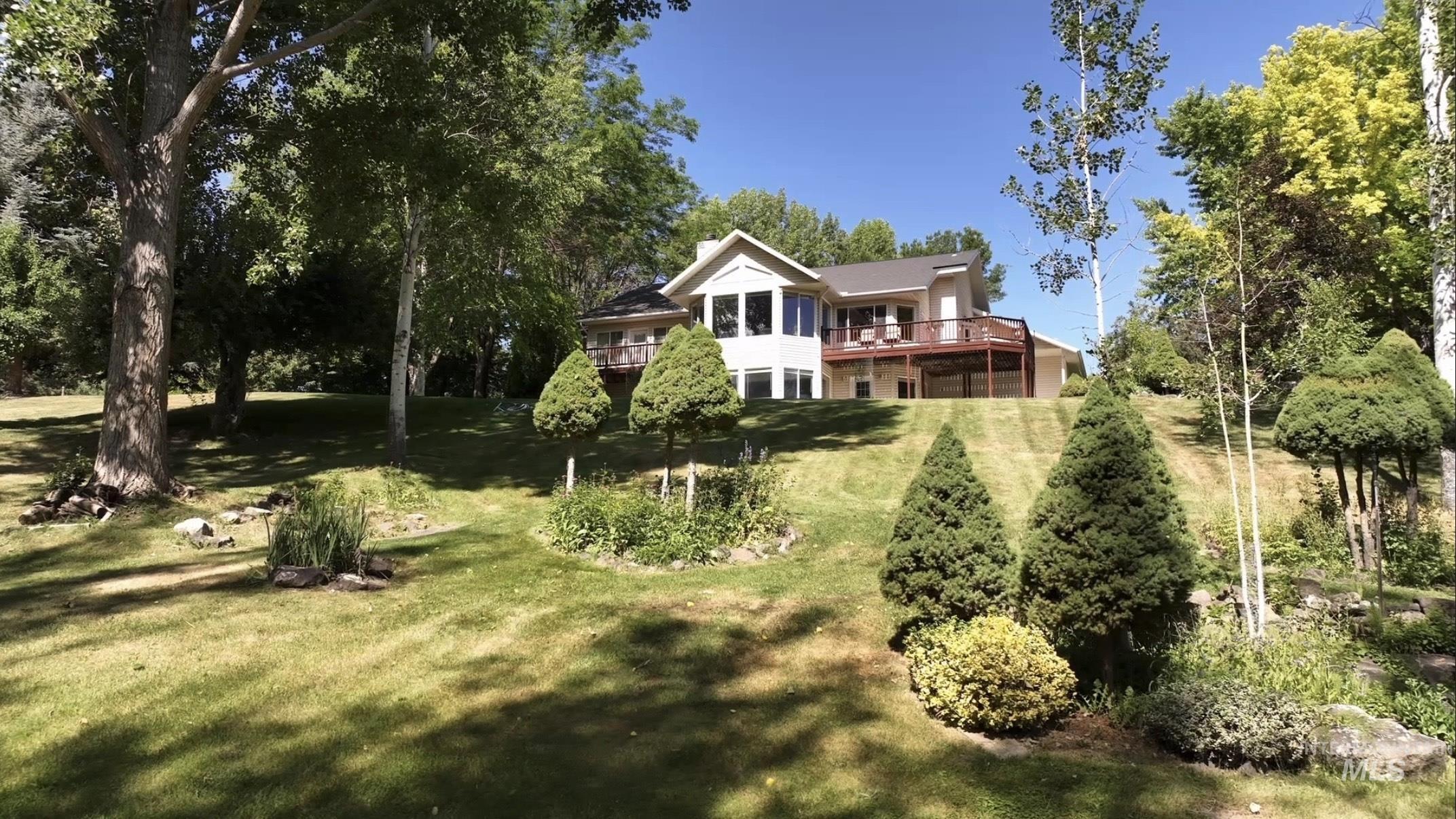Back of house with a lawn