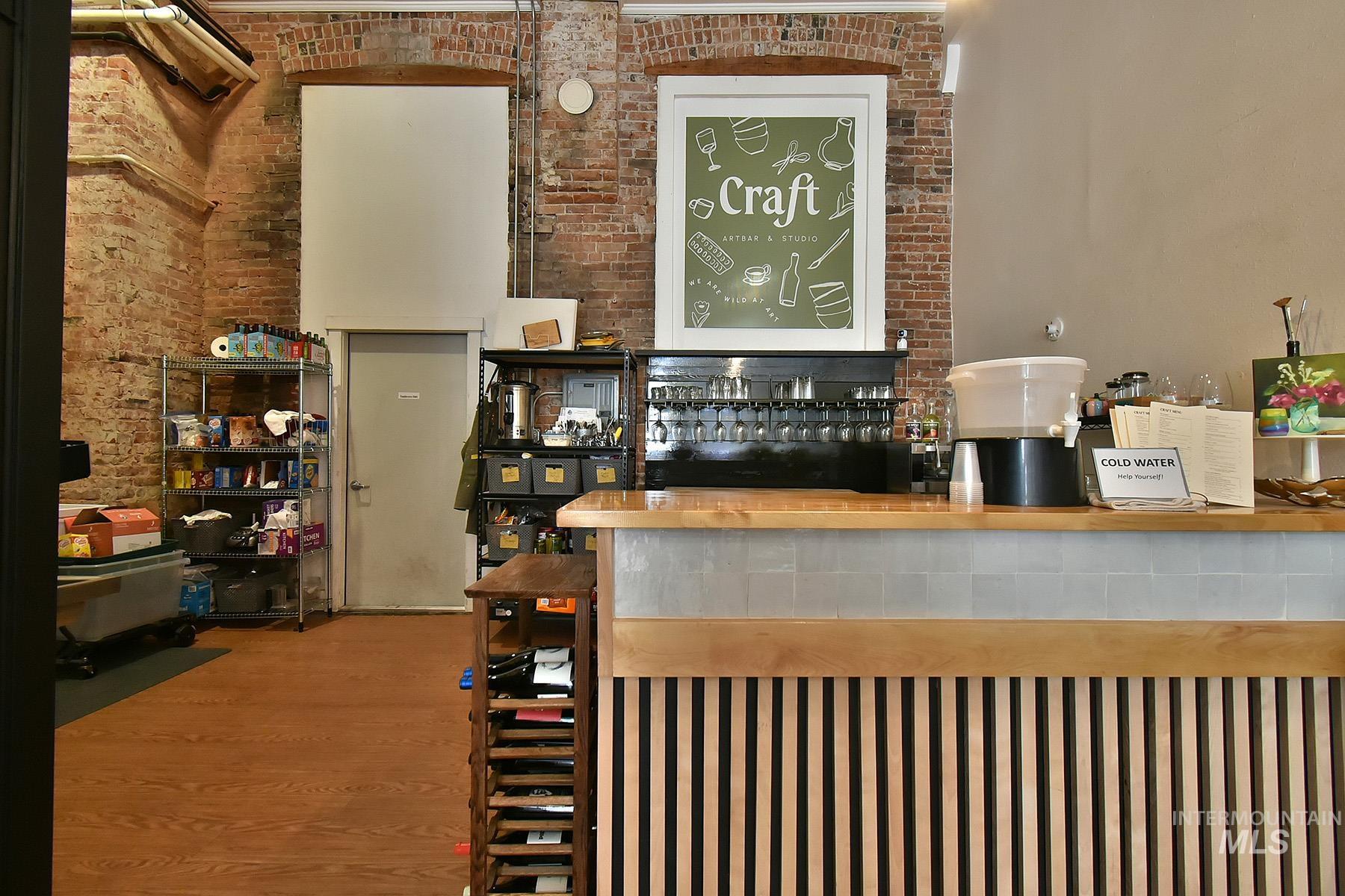 Reception area featuring a dry bar and brick wall