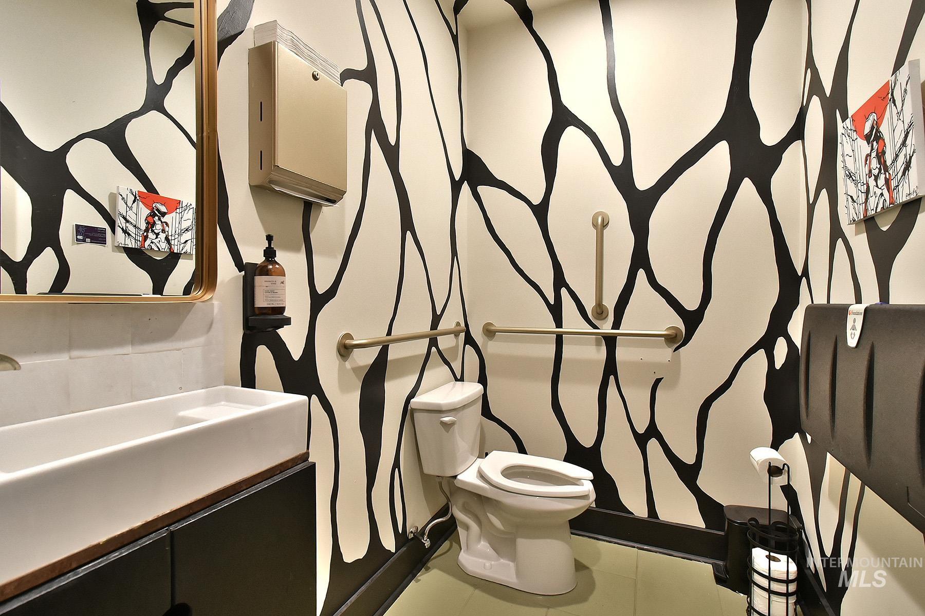 Half bathroom featuring tile patterned floors and vanity