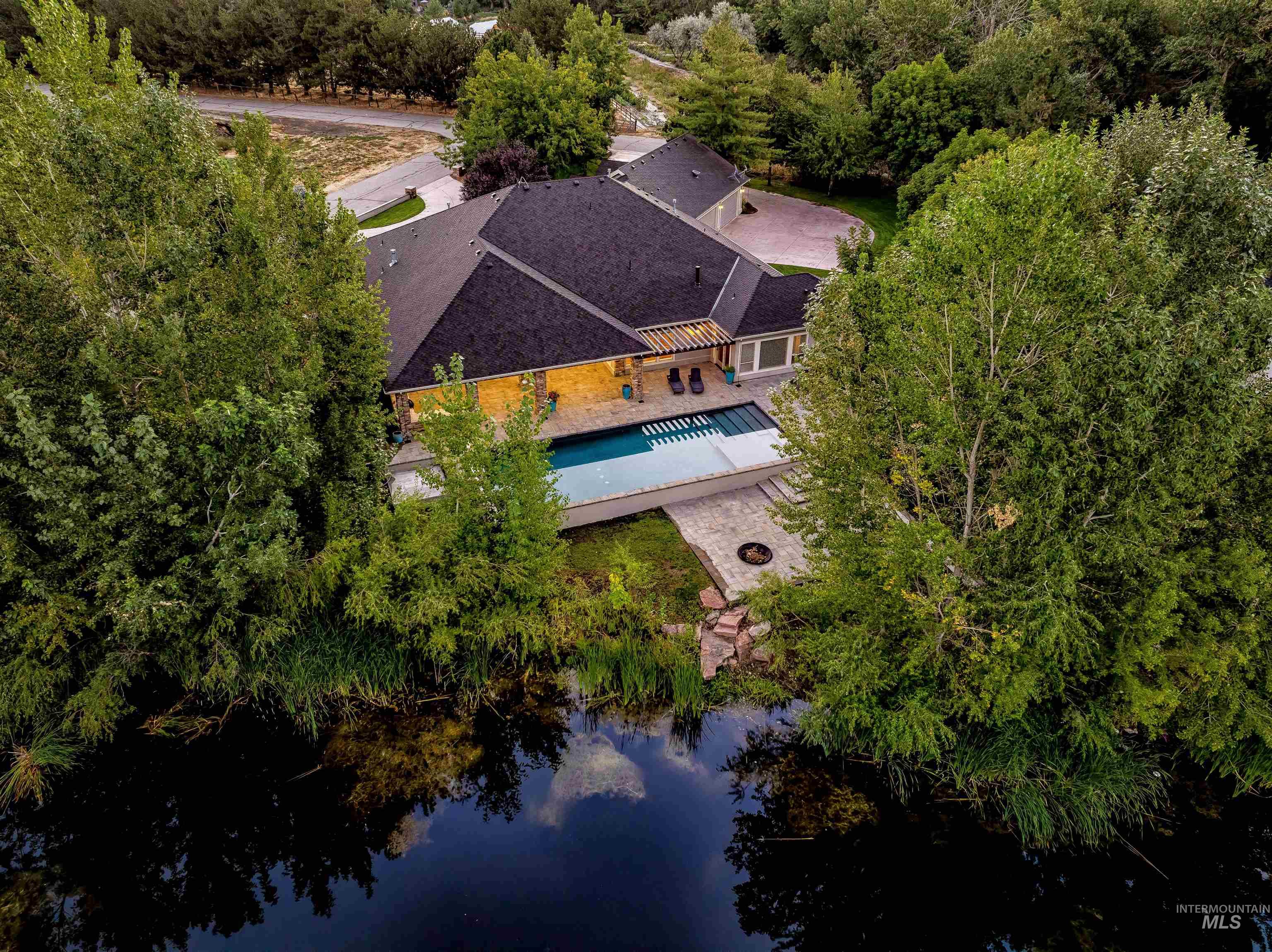 View from above of property featuring a pool and a large body of water