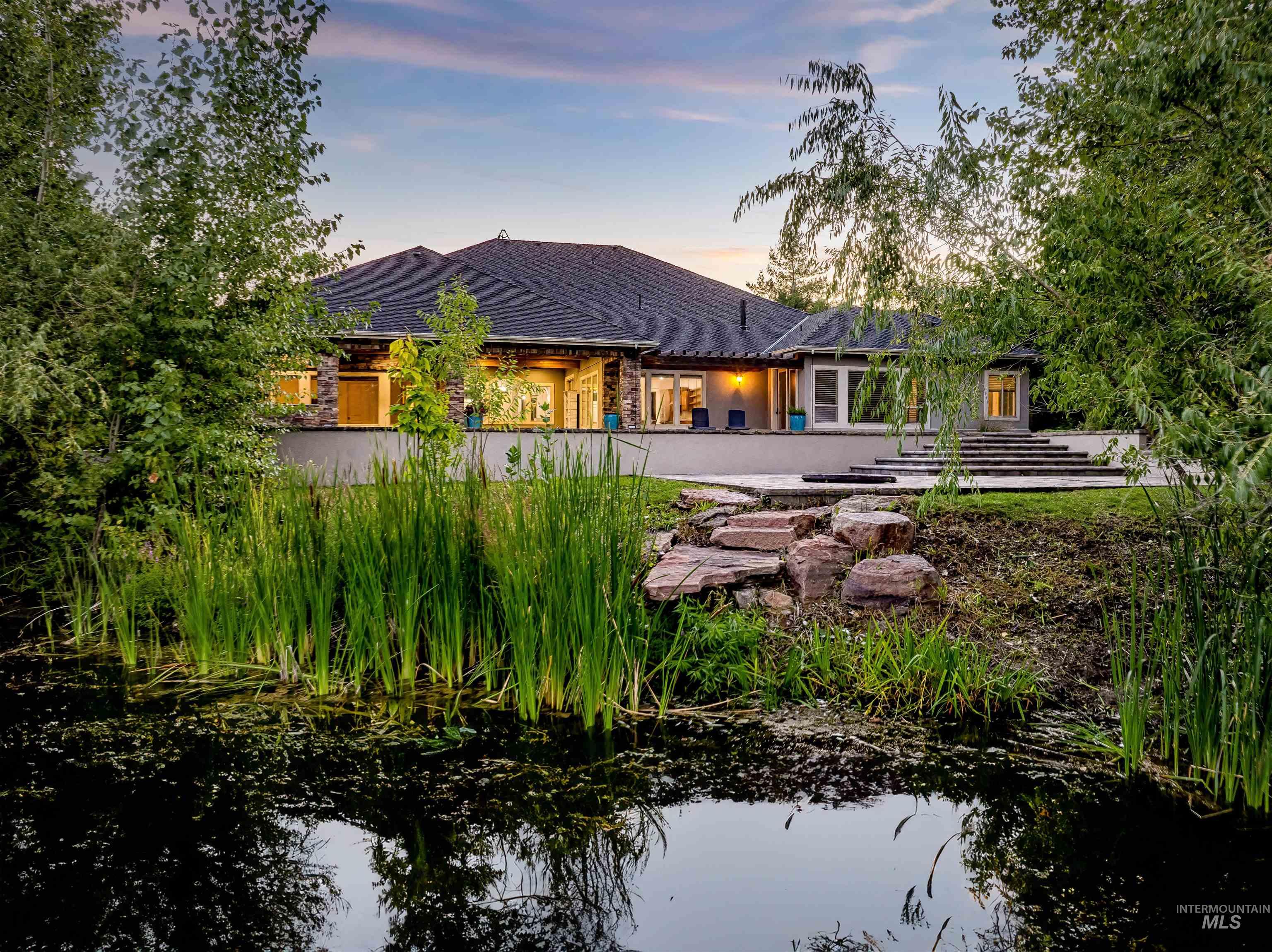 Rear view of property with a patio and roof with shingles