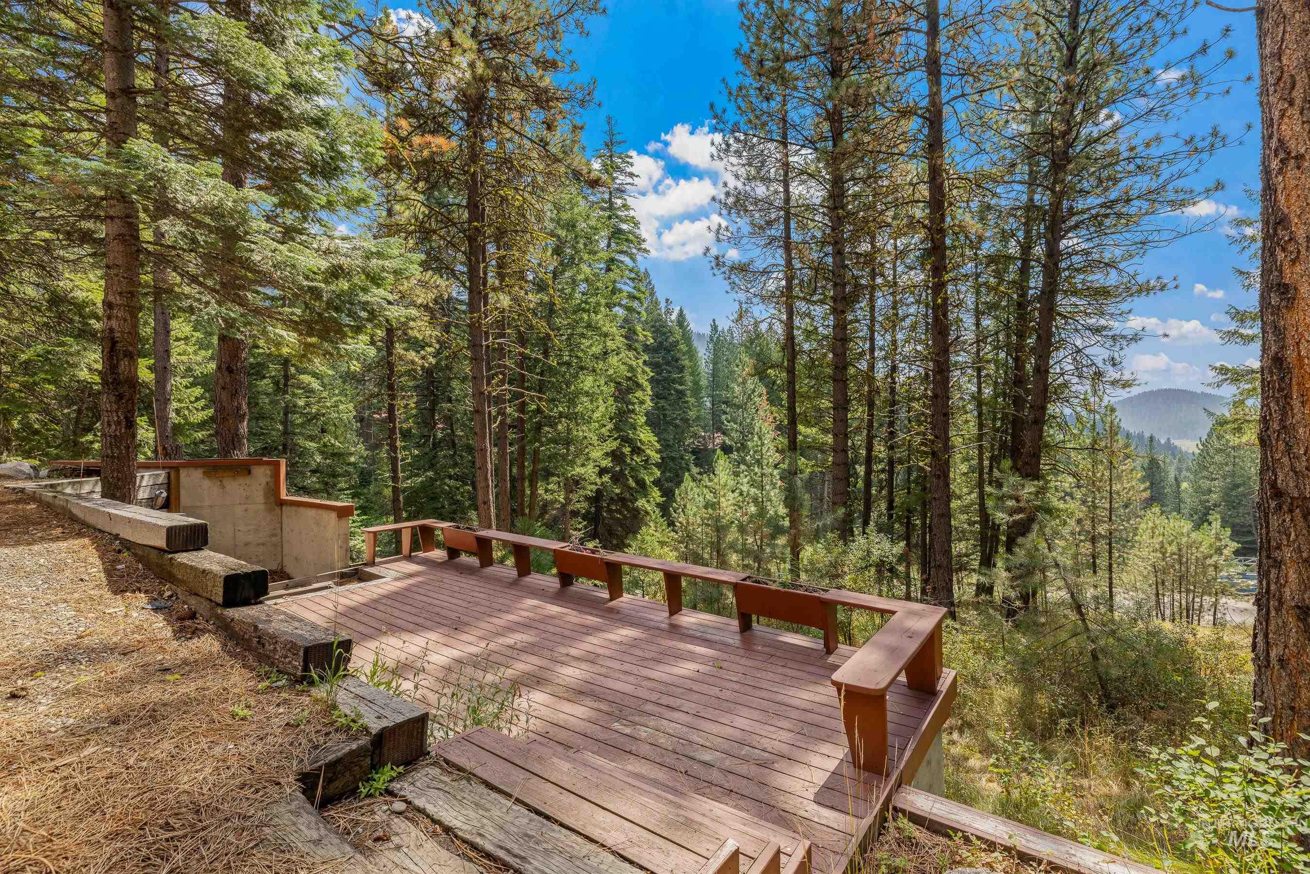 Wooden deck featuring a forest view
