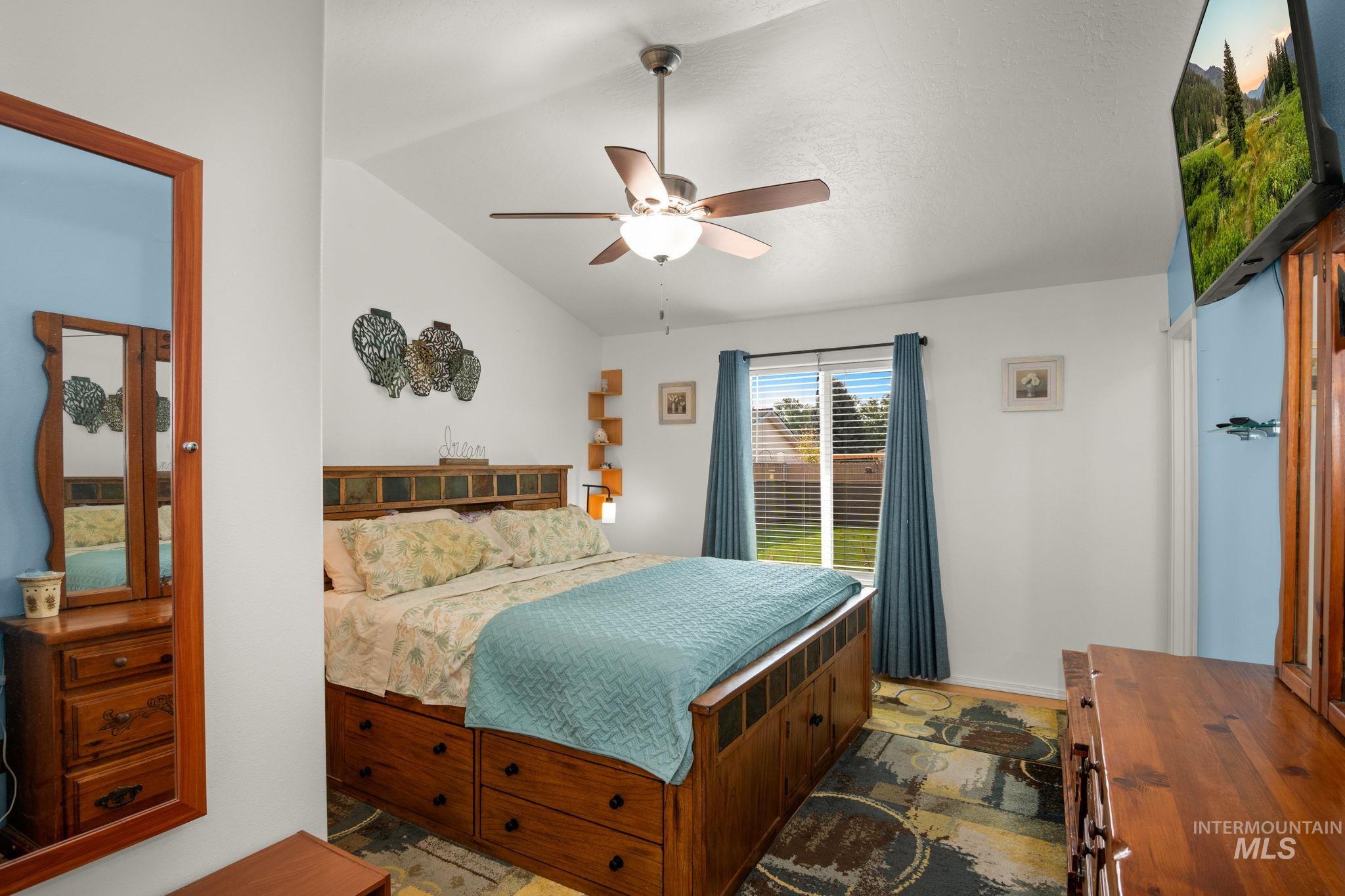 Bedroom featuring lofted ceiling and a ceiling fan