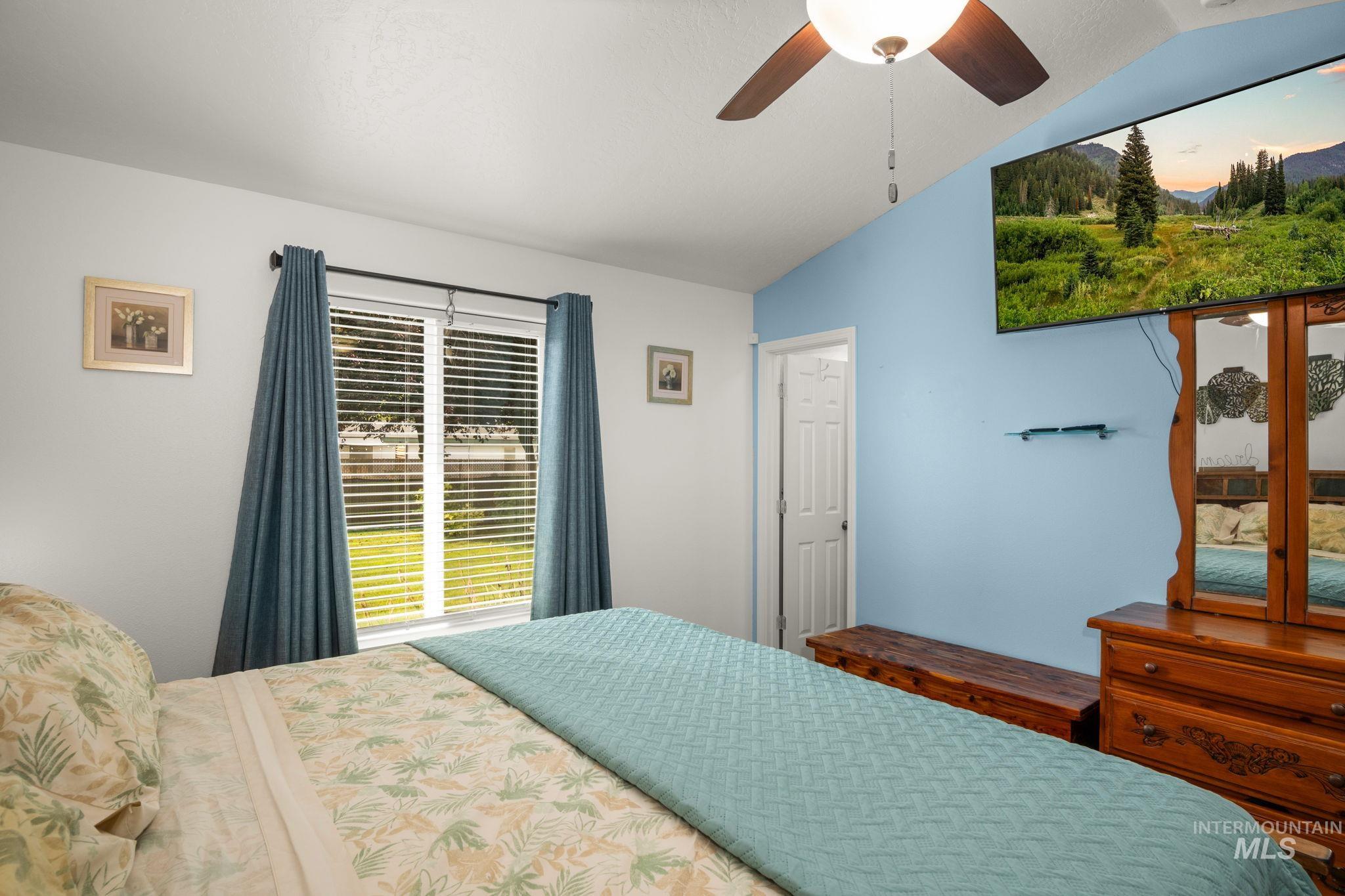 Bedroom featuring vaulted ceiling and ceiling fan
