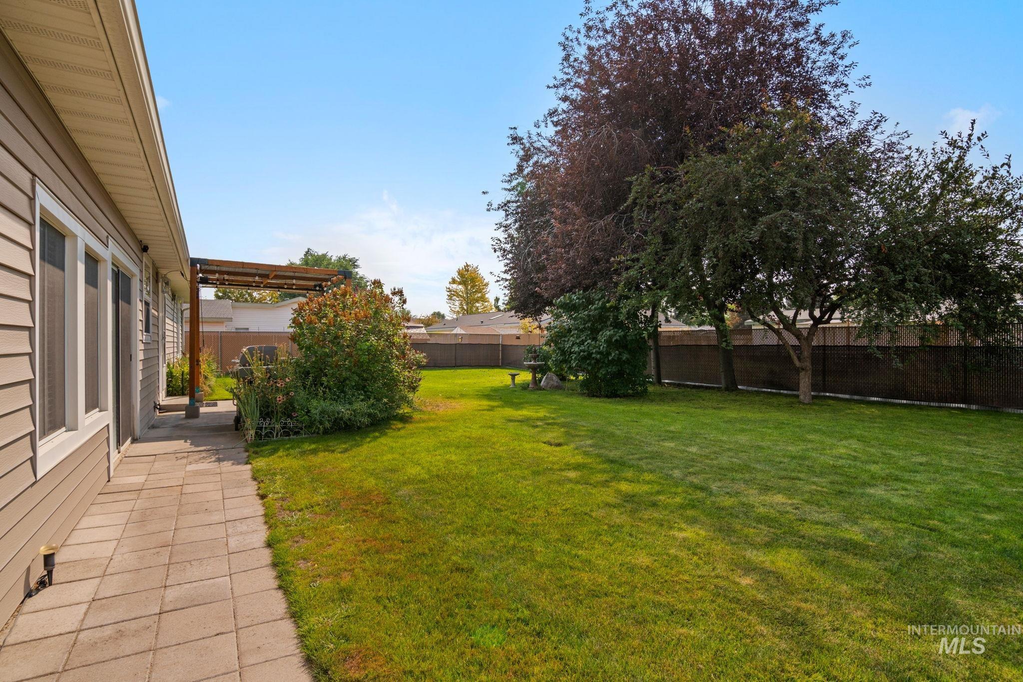 Fenced backyard with a patio area and a pergola