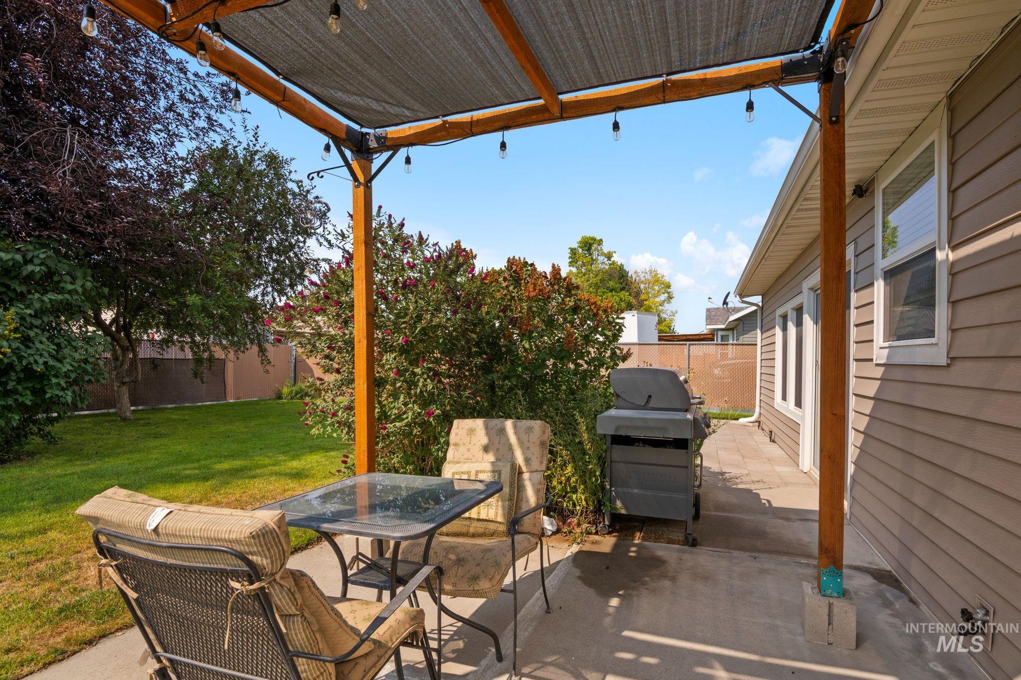 Fenced backyard featuring a patio, area for grilling, and outdoor dining area