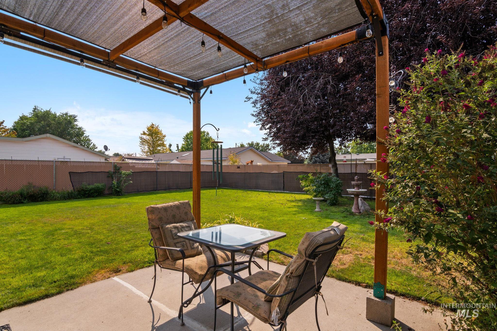 Fenced backyard with a patio and outdoor dining area