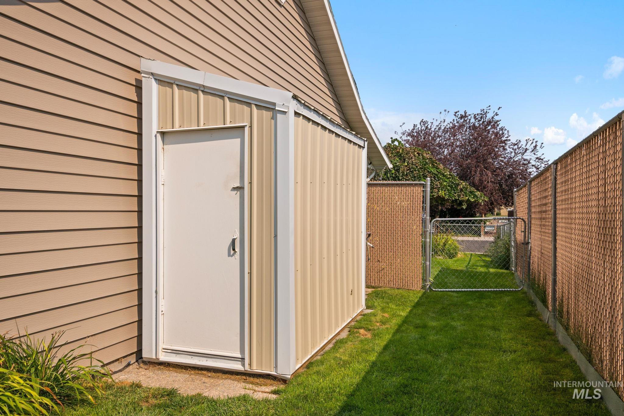View of shed featuring a gate