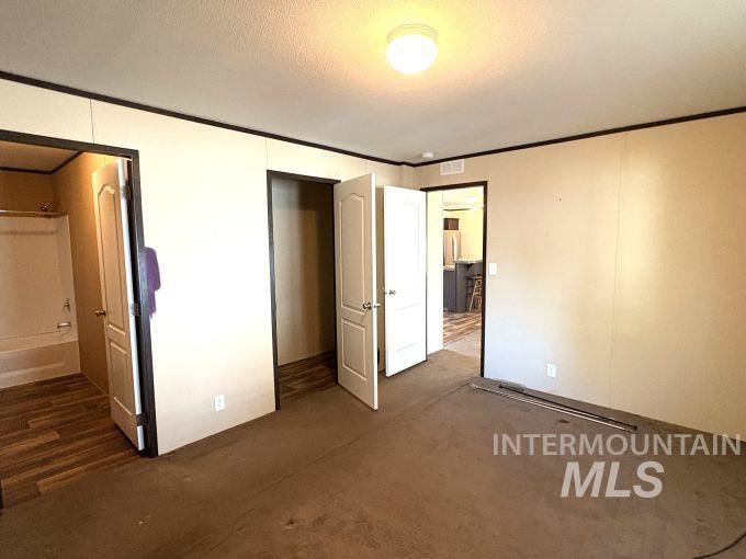 Unfurnished bedroom featuring ornamental molding
