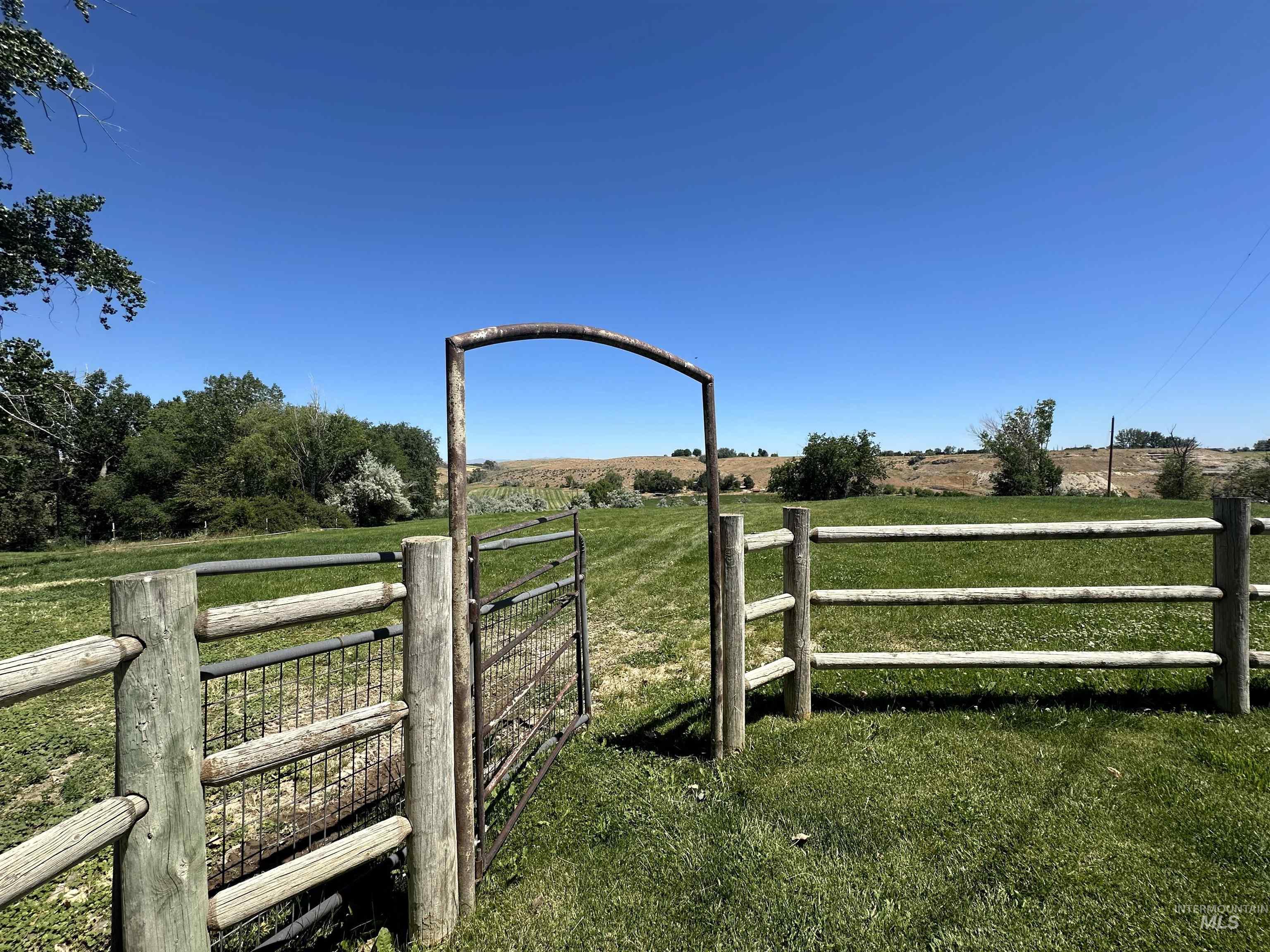 View of yard with a view of rural / pastoral area and a gate