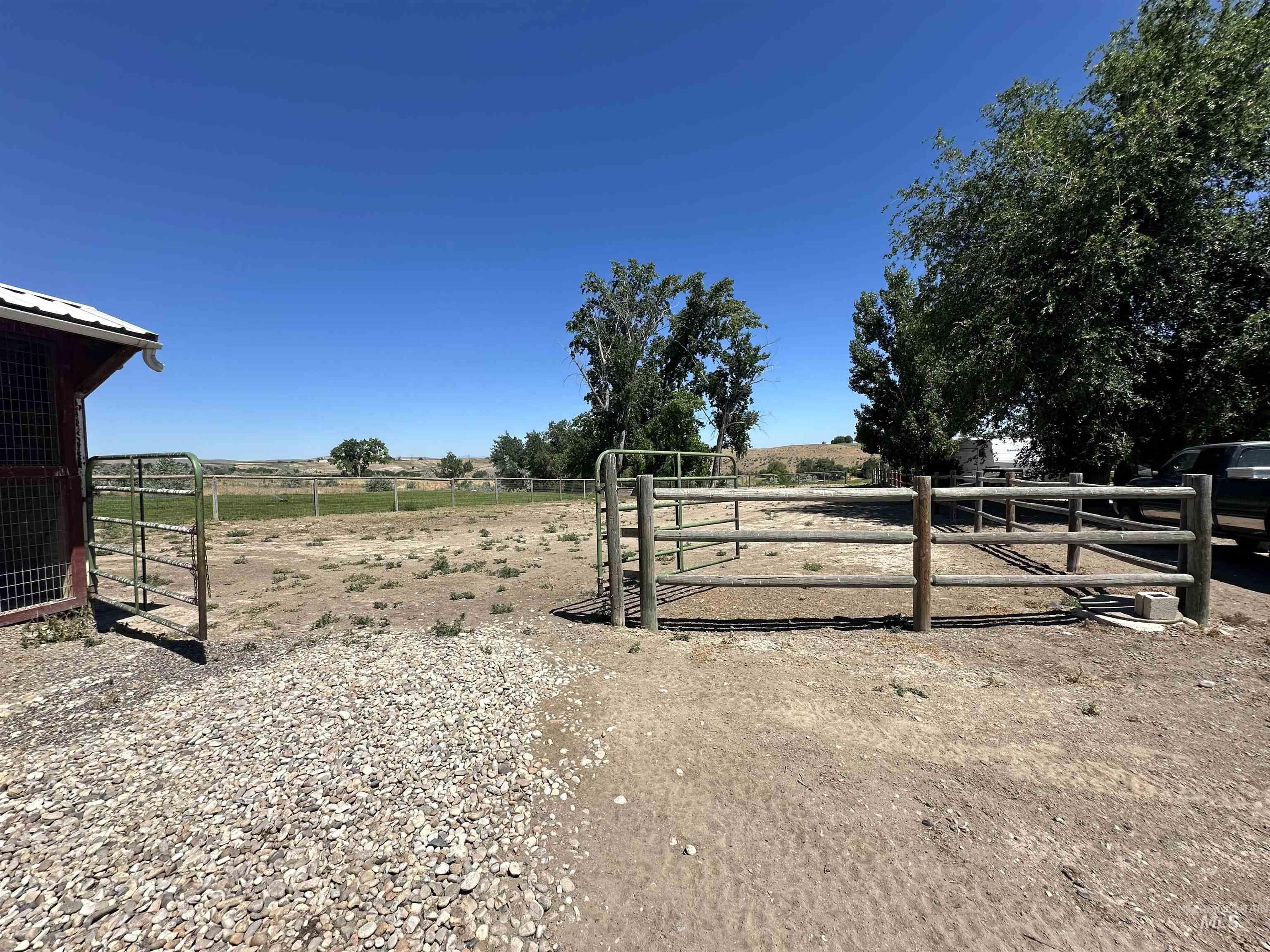 View of yard featuring a rural view and an exterior structure