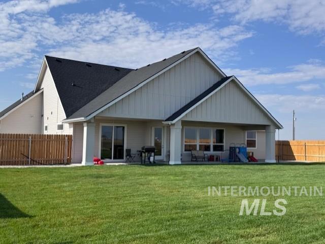 Back of property featuring a patio and board and batten siding
