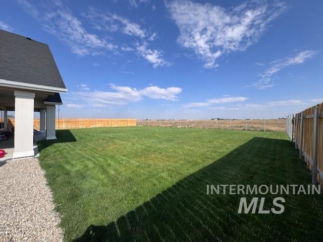 Fenced backyard with a patio area