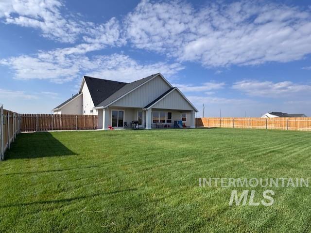 Rear view of property featuring a fenced backyard and a patio area