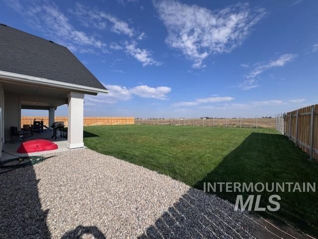 Fenced backyard featuring a patio