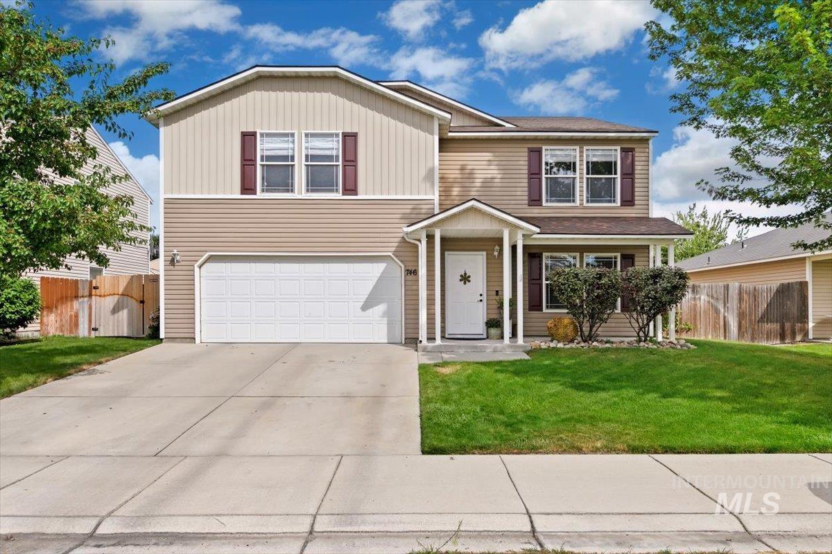 Traditional-style house featuring driveway and a garage