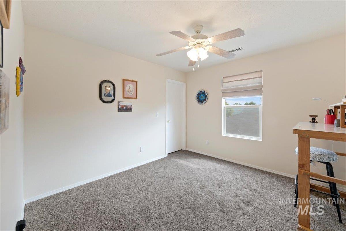 Unfurnished bedroom with carpet flooring and a ceiling fan