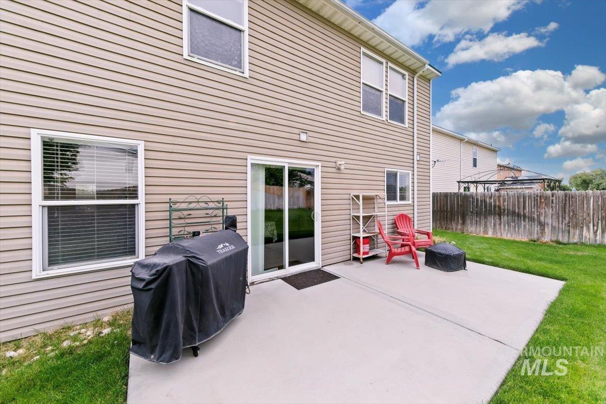 Back of house with an outdoor fire pit and a patio
