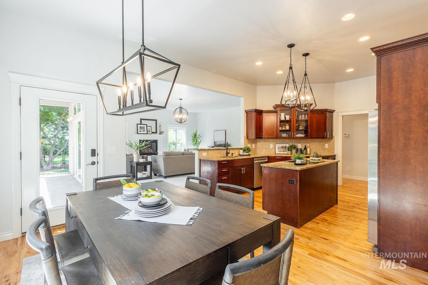 Dining area with recessed lighting, light wood-style floors, plenty of natural light, and a chandelier