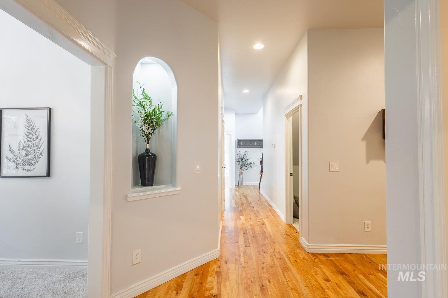 Hallway featuring light wood finished floors and recessed lighting