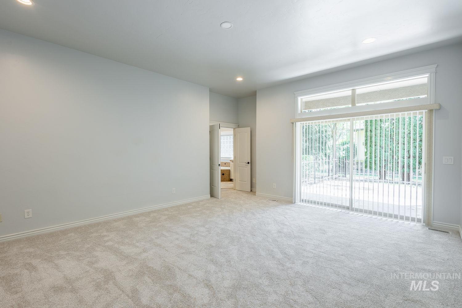 Unfurnished room with recessed lighting and light colored carpet