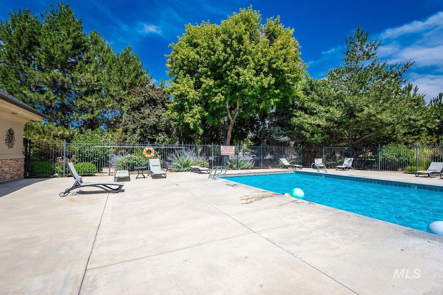Community pool featuring a patio area