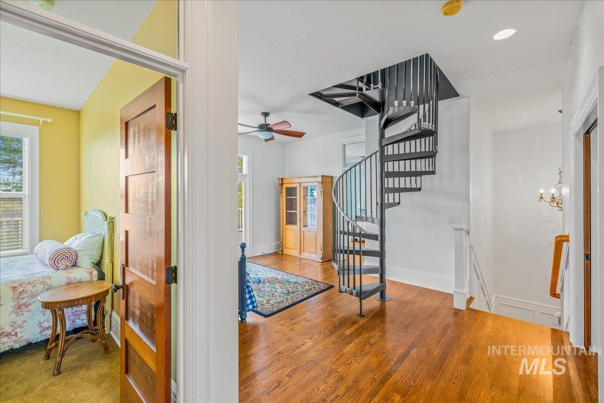 Hall with wood finished floors and stairs