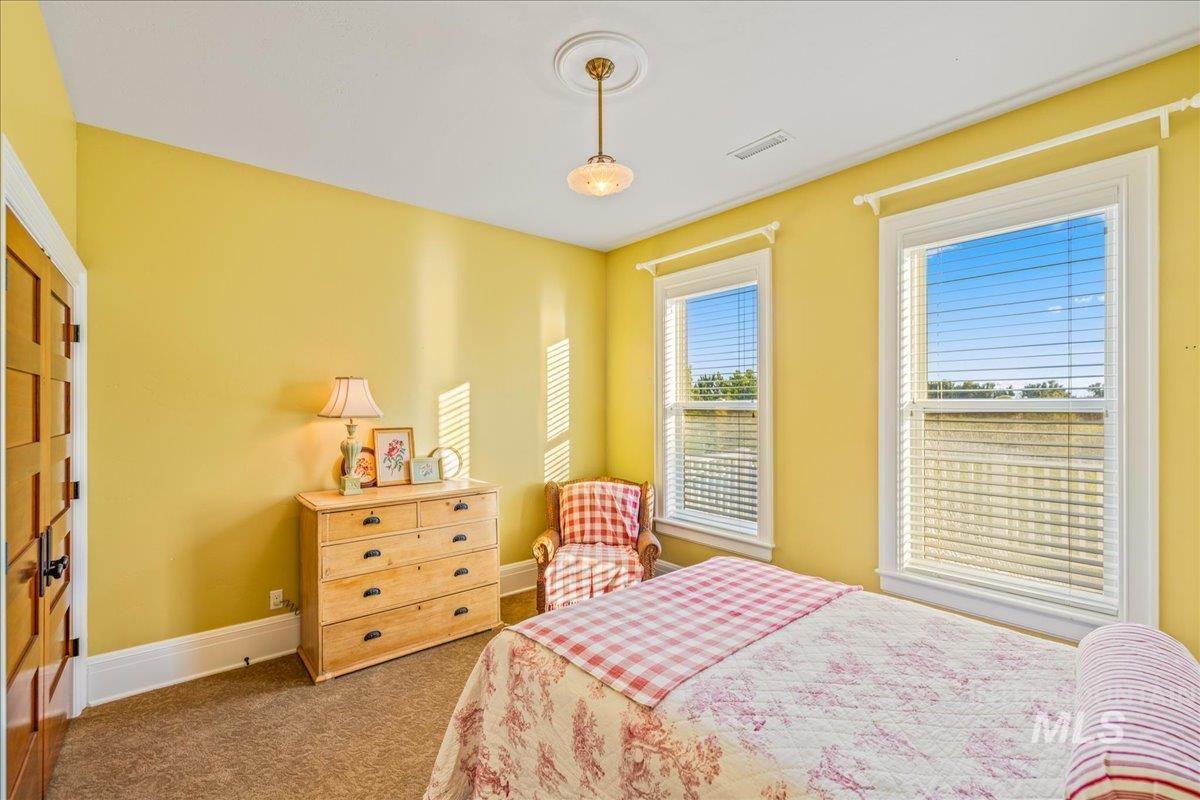 Carpeted bedroom with baseboards and a closet