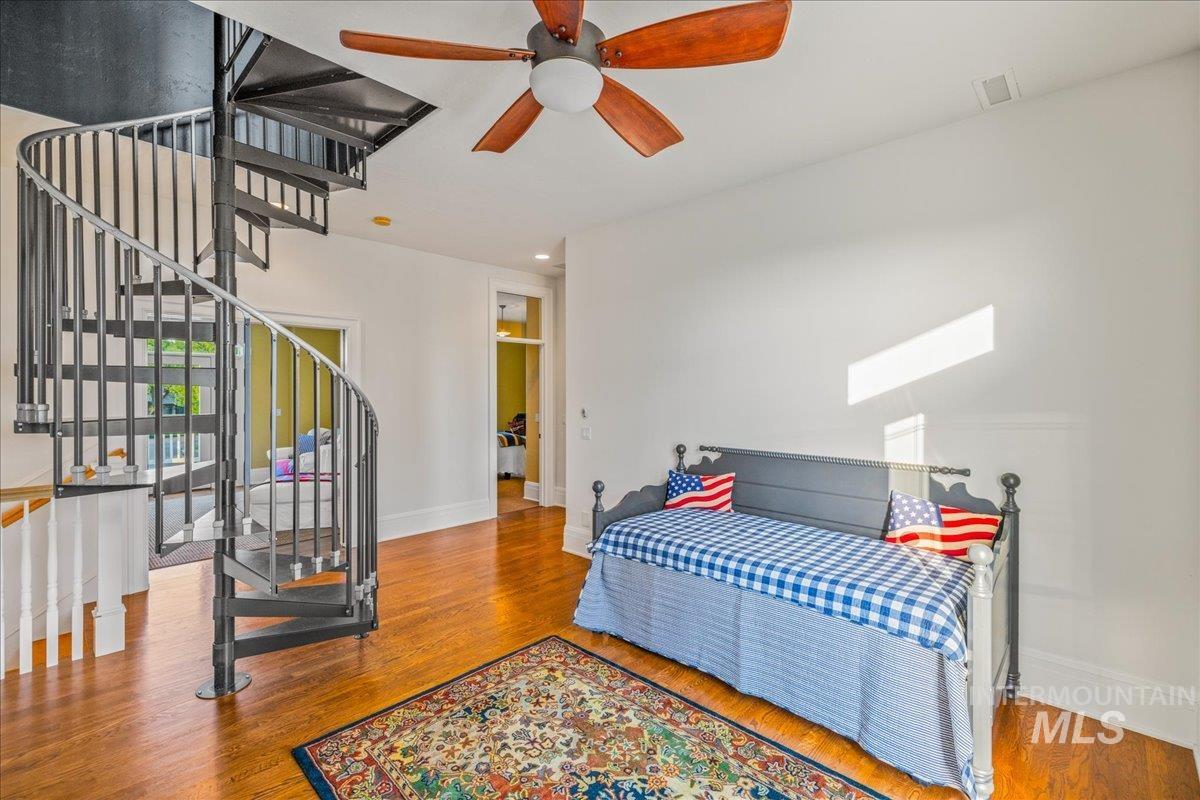 Bedroom featuring wood finished floors, ceiling fan, and recessed lighting