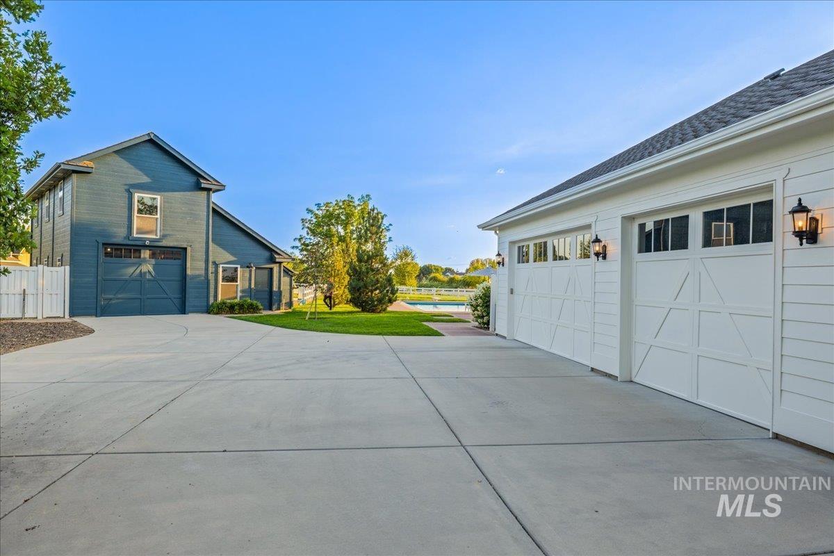 View of home's exterior featuring a garage, driveway, and a yard