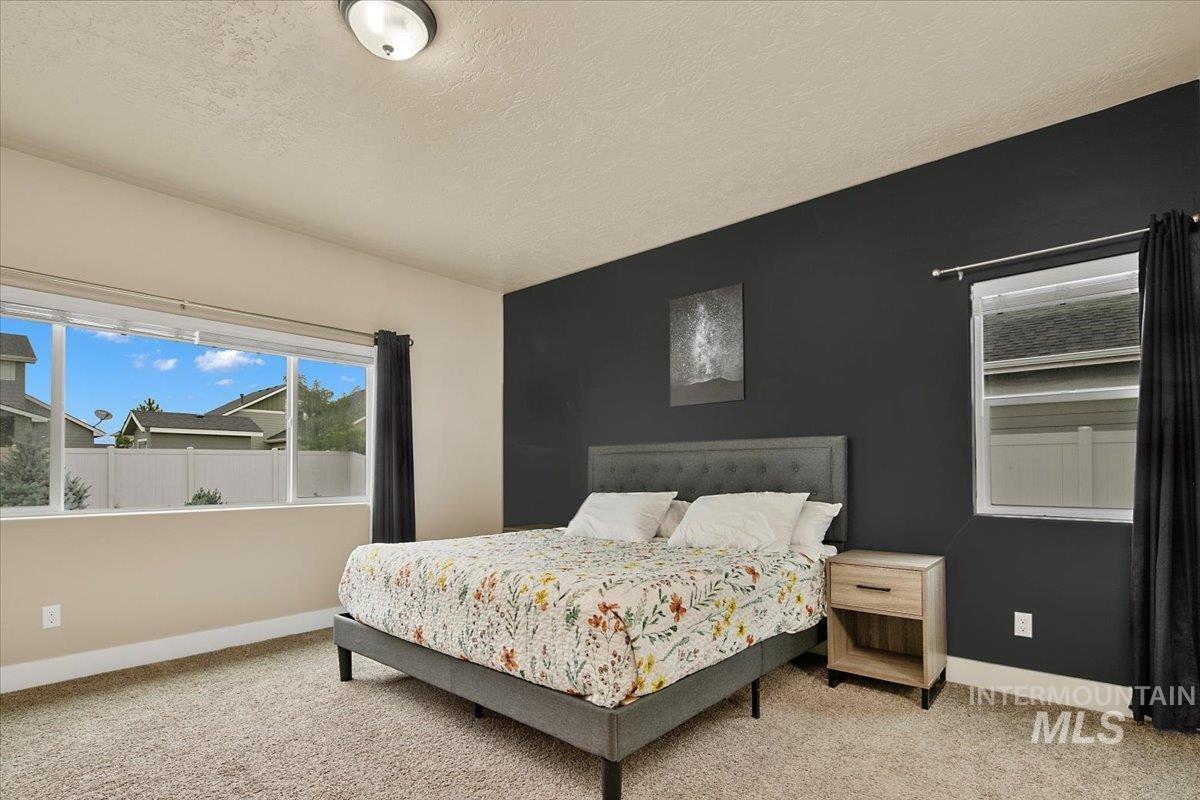 Bedroom featuring carpet floors and a textured ceiling