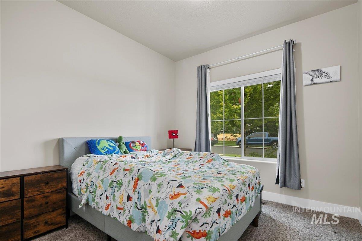 Bedroom with carpet and baseboards