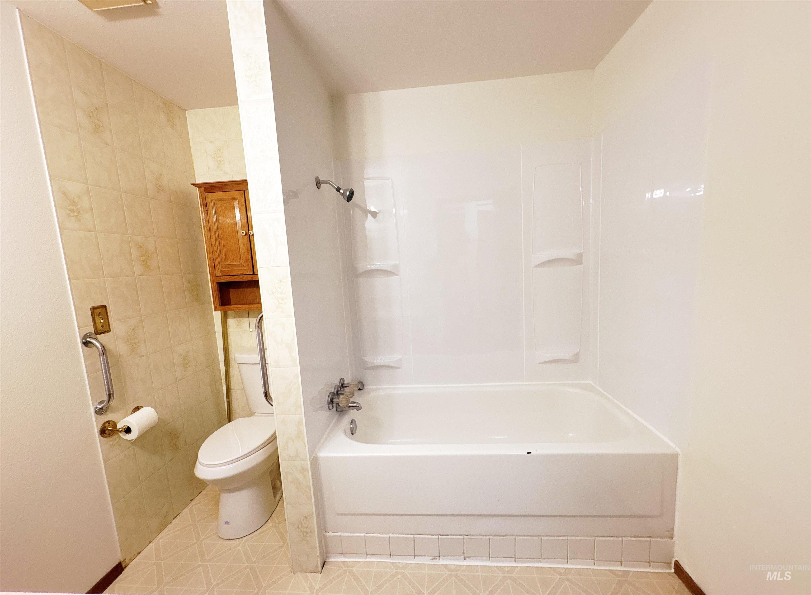 Full bathroom with shower / bathtub combination and tile patterned flooring