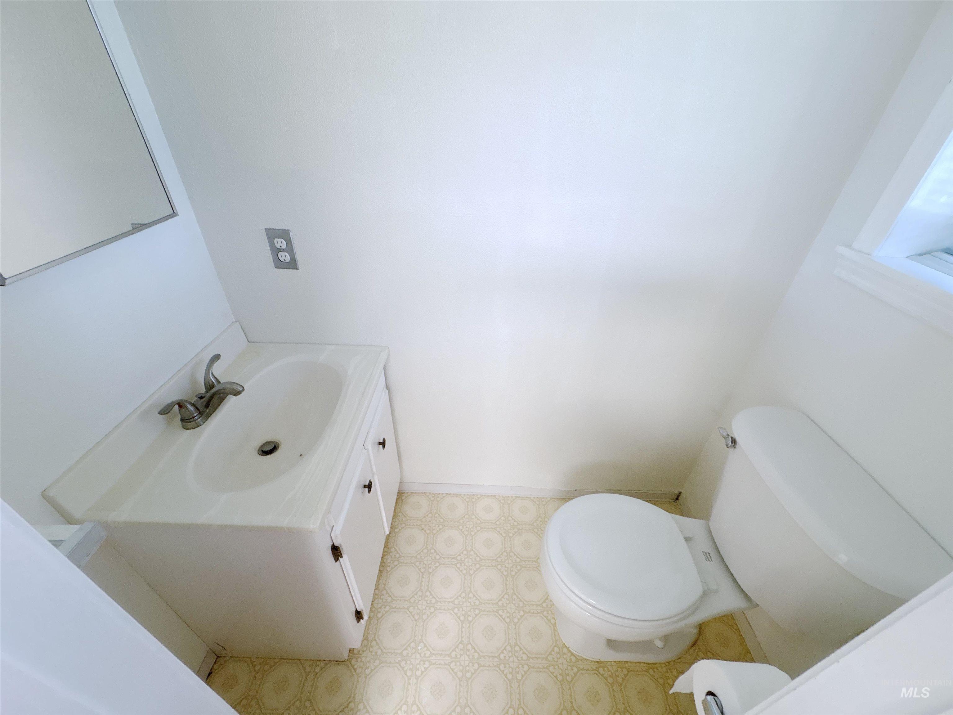 Bathroom with vanity and light floors