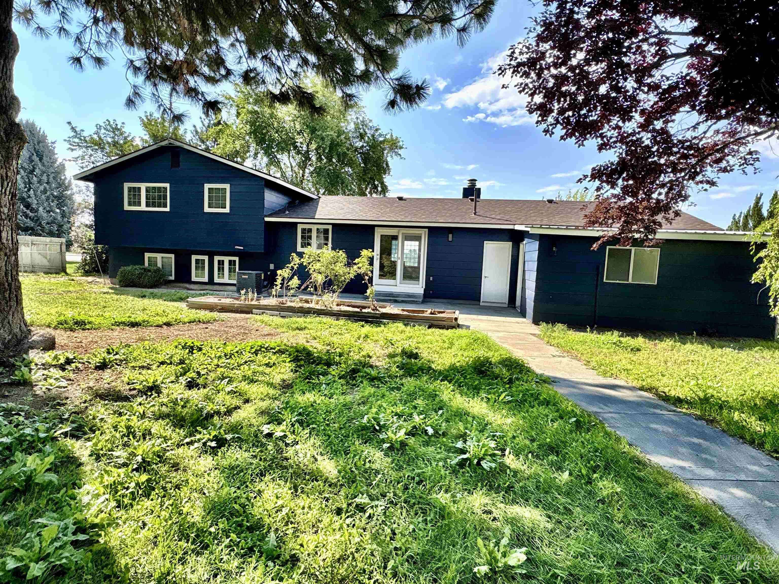 Split level home with a back lawn and french doors