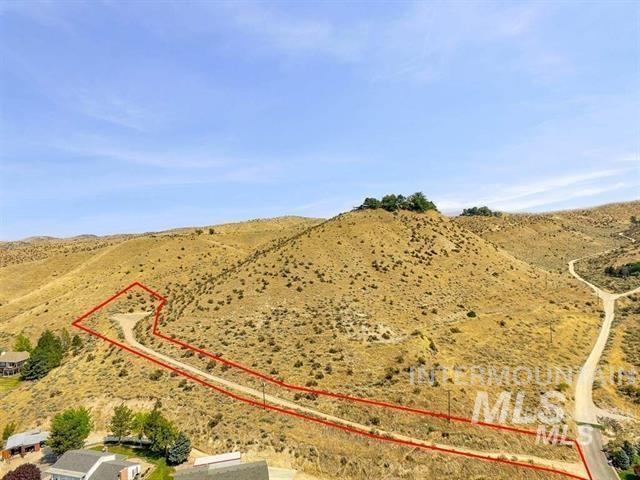 Aerial view of sparsely populated area featuring property boundaries highlighted and a desert landscape