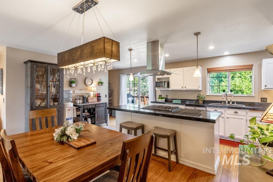 Dining space with light wood finished floors and recessed lighting