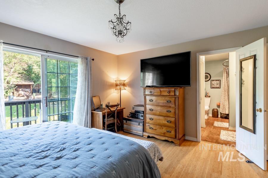Bedroom featuring wood finished floors and access to exterior