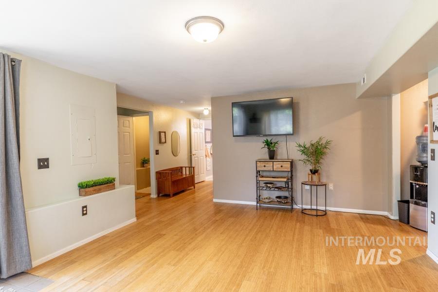 Living room featuring light wood-type flooring and electric panel