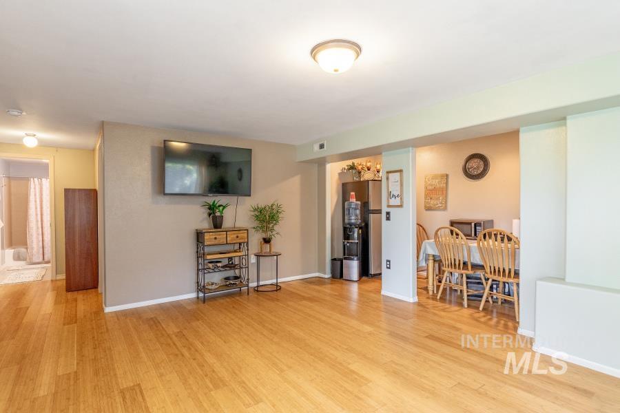 Living area with light wood-style floors and a chandelier
